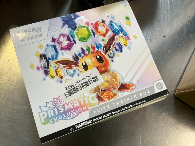Photo 1 of Pokémon: Scarlet & Purple Elite Trainer Set - Prismatic Evolutions of the Pokémon TCG (1 Fully Illustrated Promo Card, 9 Booster Packs & Premium Game Accessories)