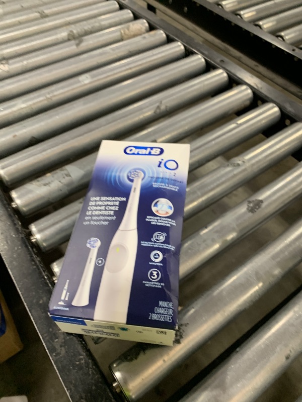 Photo 1 of Oral-B Rechargeable Electric Toothbrush, iO2 Starter Kit, 3 Cleaning Modes, Automatic Pressure Sensor to Protect Gums, 2 Brush Heads, Pure White