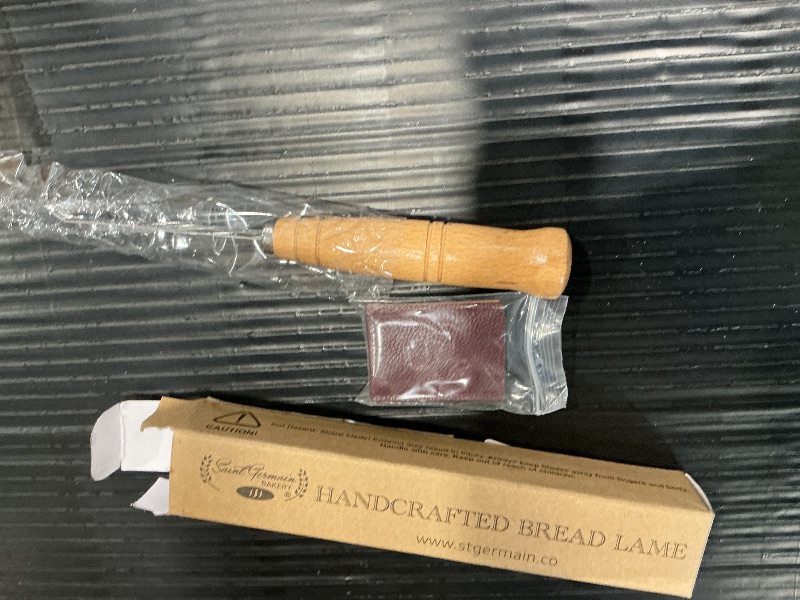 Photo 1 of "SAINT GERMAIN Premium Hand Crafted Bread Lame for Dough Scoring Knife, Lame Bread Tool for Sourdough Bread Slashing with 10 Blades Included with Replacement with Authentic Leather Protector Cover"