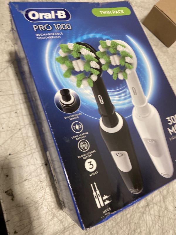 Photo 1 of Oral-B Pro 1000 CrossAction Electric Toothbrush, Black and White, 2 Count