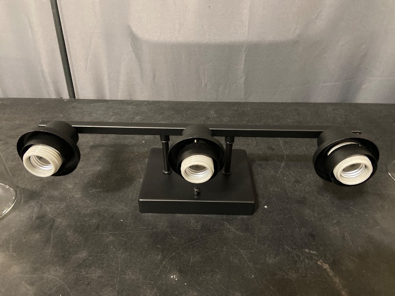 Photo 1 of 3-light matte black bathroom vanity light fixture complete with clear cylindrical glass shades and mounting hardware