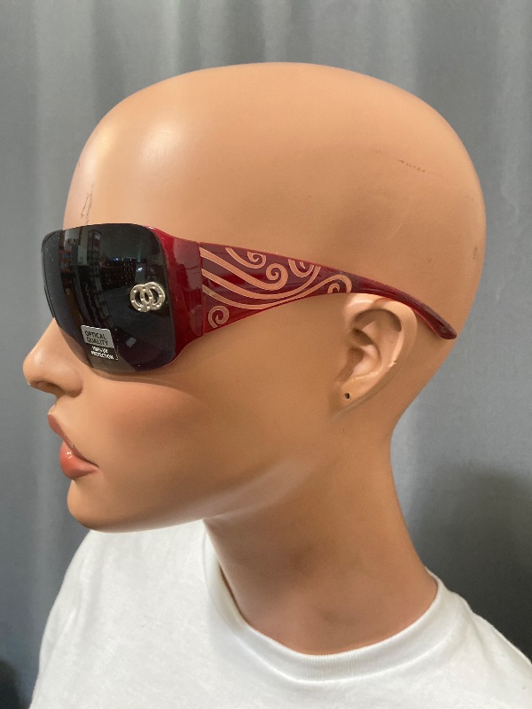 Photo 1 of Celebrity Styles sunglasses feature a rimless, wrap-around design with a single dark shield lens.