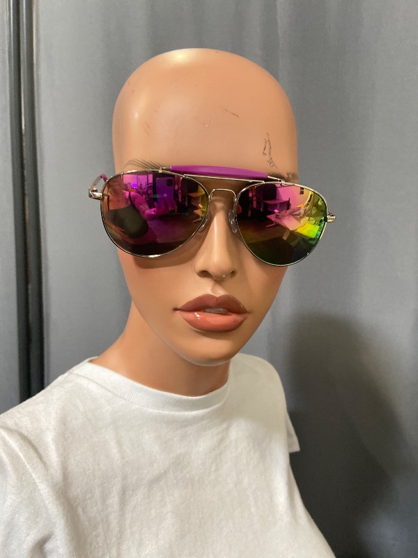 Photo 1 of Aviator sunglasses feature a distinctive silver metal frame paired with vibrant purple mirror lenses