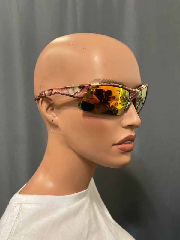 Photo 1 of sunglasses feature a camouflage frame and orange reflective lenses