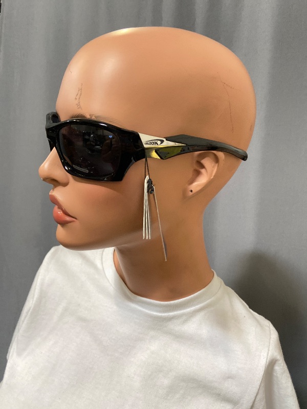 Photo 1 of Black X Loop sunglasses feature a wrap-around frame design and white branding on the temple.
