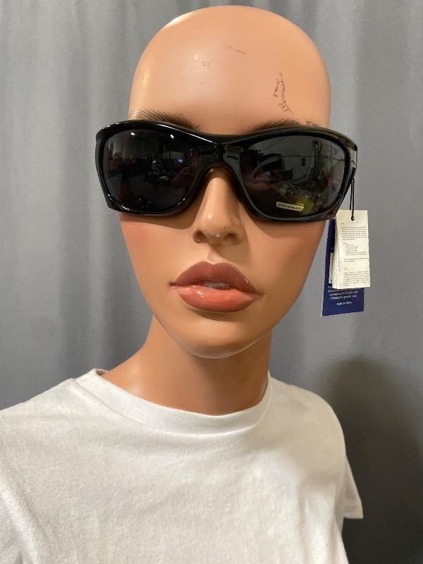 Photo 1 of Black X Loop sunglasses feature a wrap-around frame design and white branding on the temple.