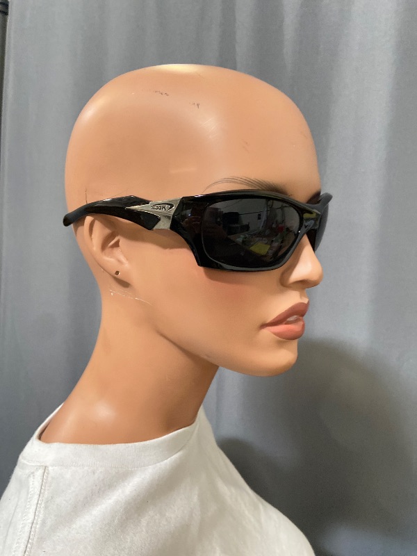 Photo 1 of Black X Loop sunglasses feature a wrap-around frame design and white branding on the temple.