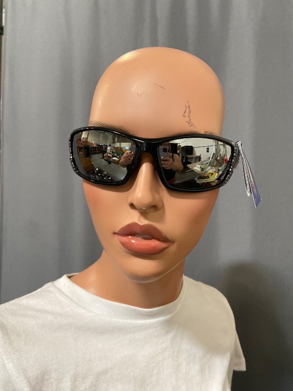 Photo 1 of sunglasses feature a distinct carbon fiber pattern on the frames and mirrored lenses