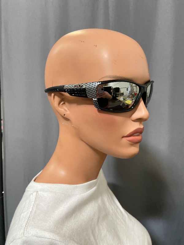 Photo 1 of sunglasses feature a distinct carbon fiber pattern on the frames and mirrored lenses