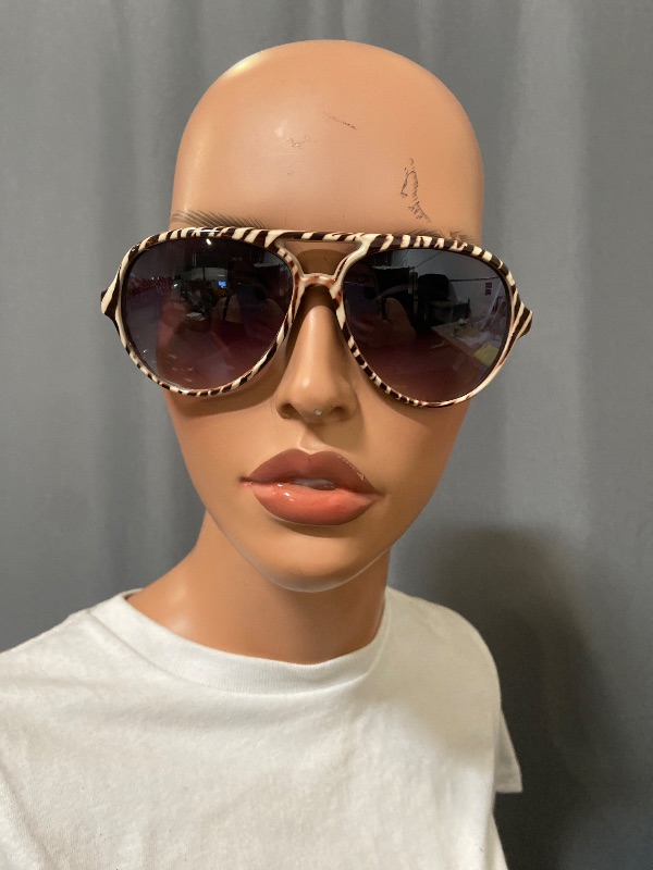 Photo 1 of Aviator sunglasses featuring a distinctive zebra-striped frame and gradient lenses