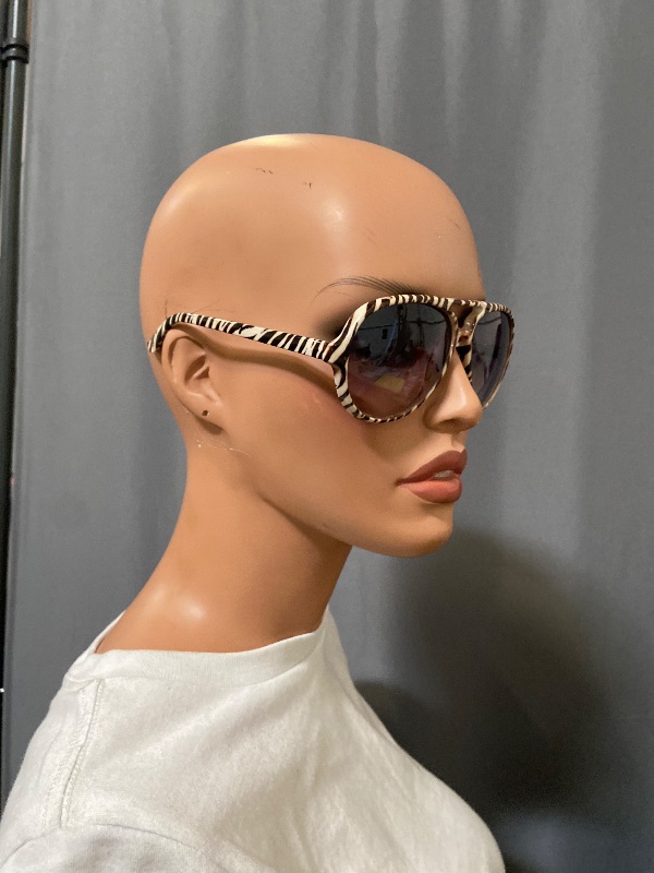 Photo 1 of Aviator sunglasses featuring a distinctive zebra-striped frame and gradient lenses