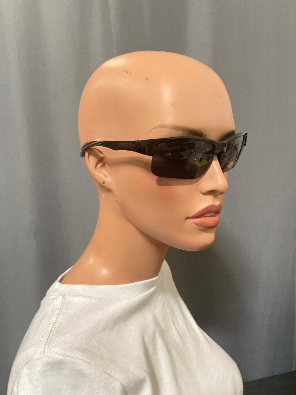 Photo 1 of sunglasses featuring a grey smoke frame and brown sides with black lenses.