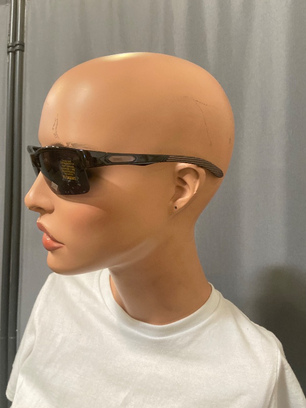 Photo 1 of sunglasses featuring a grey smoke frame and brown sides with black lenses.