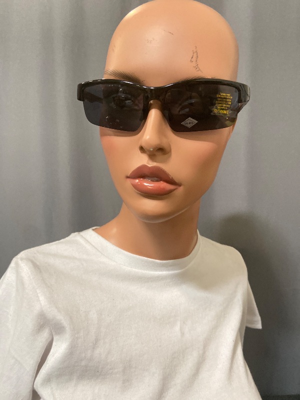 Photo 1 of sunglasses featuring a grey smoke frame and brown sides with black lenses.