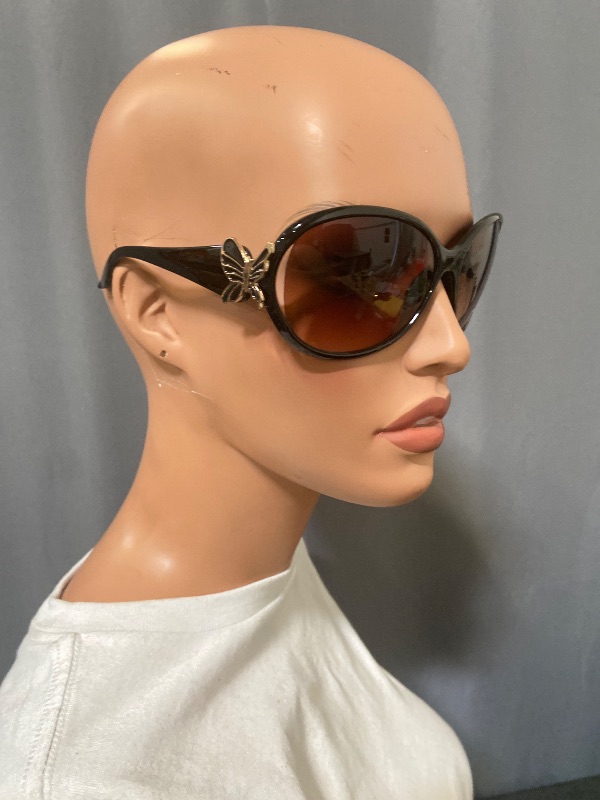 View 3 of  sunglasses feature distinct butterfly-shaped metal decorations on the temples