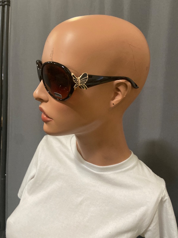 View 2 of  sunglasses feature distinct butterfly-shaped metal decorations on the temples