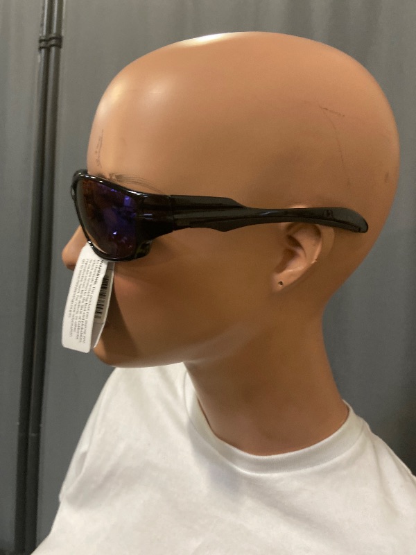 Photo 1 of black wrap-around sunglasses resemble the Oakley Straight Jacket model with purple lenses.