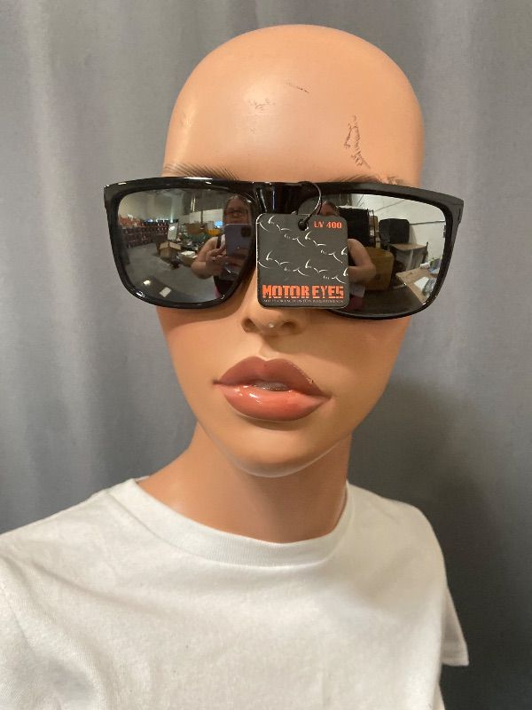 Photo 1 of sunglasses feature a black square frame with mirrored lenses and branded metal detailing on the temple