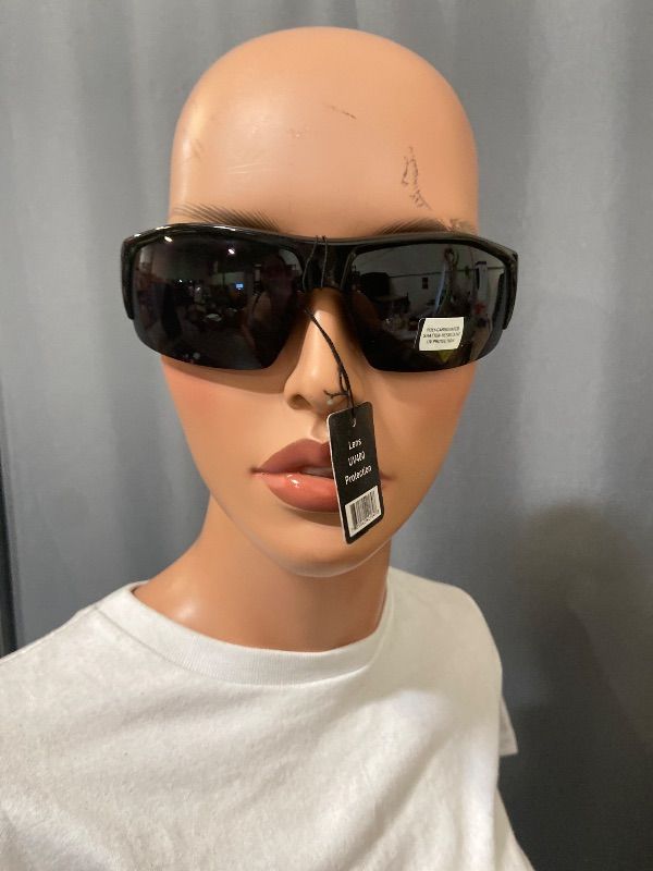 View 1 of black sunglasses feature a polarized shield design and a UV400 lens.