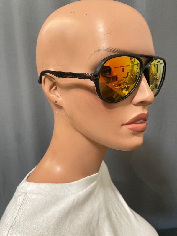 Photo 1 of black-framed aviator sunglasses feature distinctive red mirror lenses.