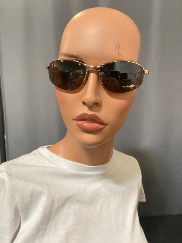 Photo 1 of gold-framed sunglasses resemble the Giorgio Armani 1521 743 model, featuring a gold metal sports wrap design.