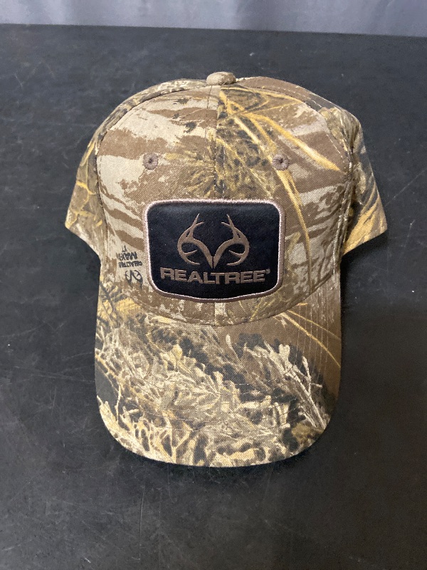 Photo 1 of  Realtree structured baseball hat features a distinctive camouflage pattern and a centered embroidered logo patch