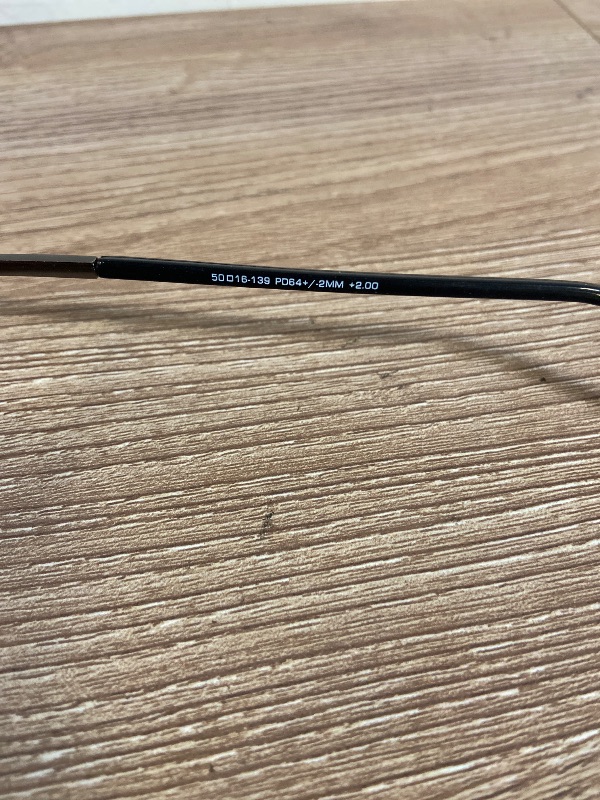 Photo 1 of brown metal eyeglasses are a classic rectangular style designed with comfortable spring hinges, "PL0413 DEAN GUN" inscribed on the temple +2.00 lens power.