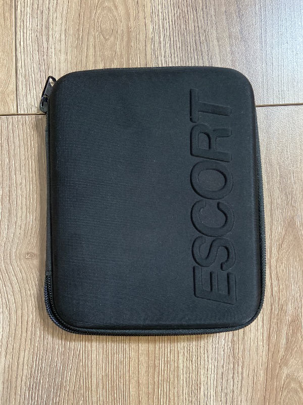 Photo 1 of black, hard-shell carrying case branded with the "ESCORT" logo, designed specifically for radar detectors