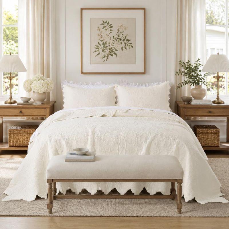 Photo 1 of elegant, vintage-style cream/beige matelassé jacquard quilt cover featuring a traditional damask floral medallion pattern and distinct scalloped or ruffled side borders