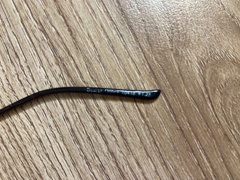 View 3 of +1.25 rimless reading glasses feature a minimalist, frameless rectangular design with sleek black metal temple arms and screw-mount connections.