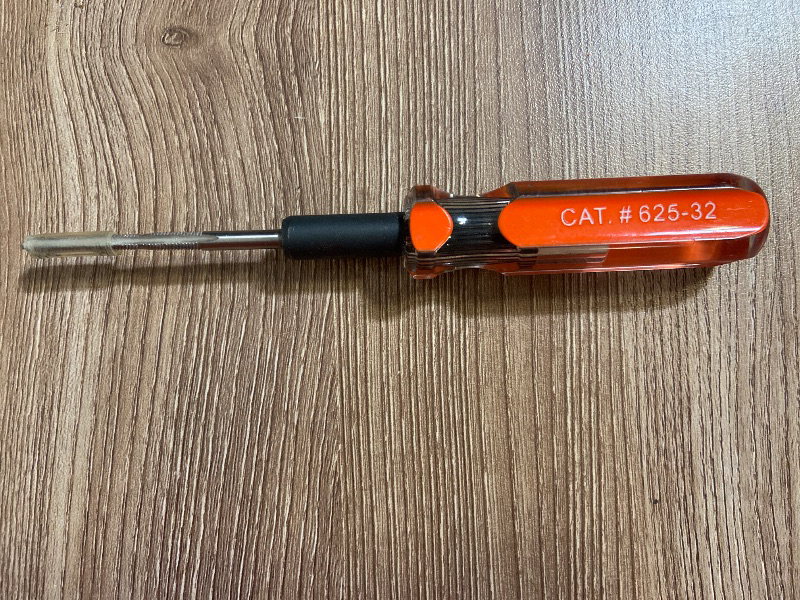 Photo 1 of Klein Tools Triple Tap Tool (Model 625-32), featuring an orange cushion-grip handle and a reversible/replaceable metal tap blade. It is designed for electrical and mechanical work to clean, form, or re-thread screw holes