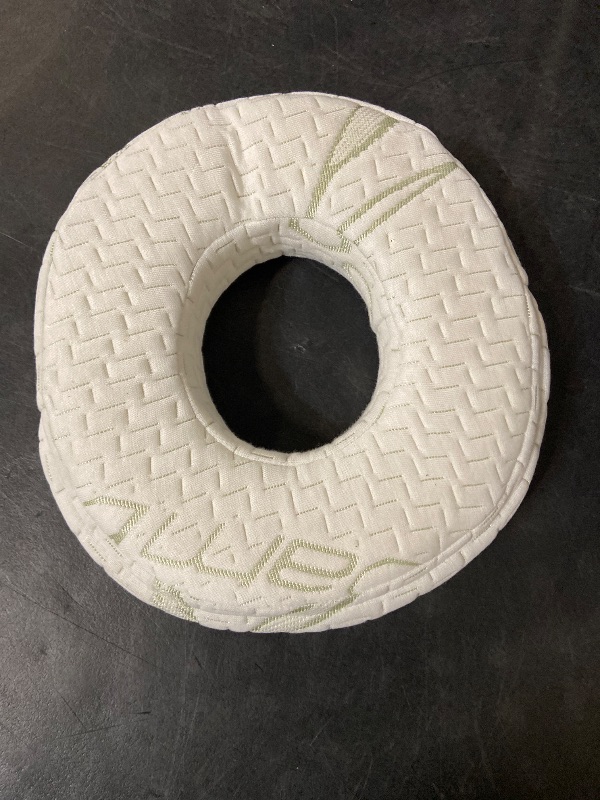 View 4 of donut-shaped ear piercing and pressure relief pillow featuring a textured white bamboo-blend fabric cover.