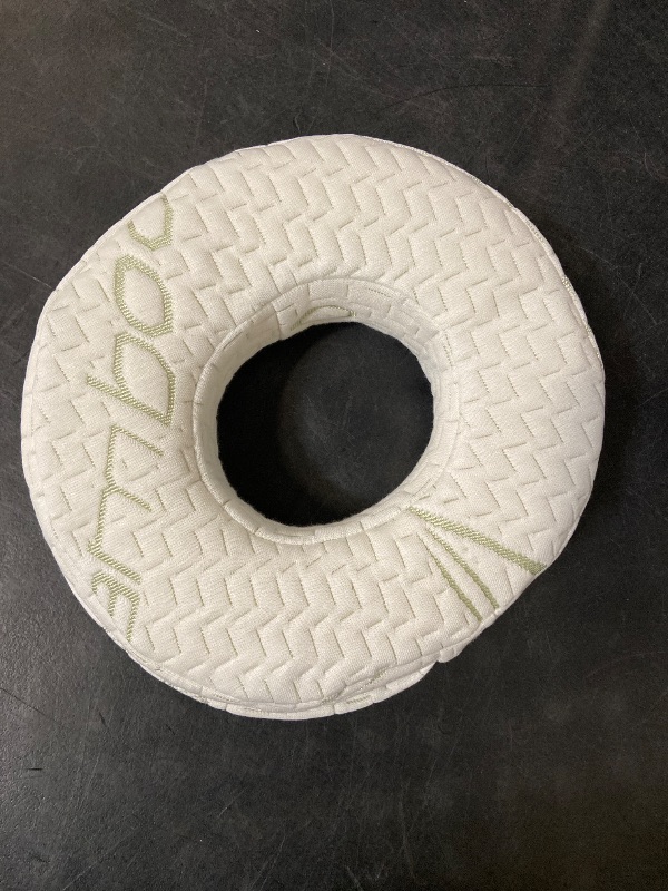 View 2 of donut-shaped ear piercing and pressure relief pillow featuring a textured white bamboo-blend fabric cover.