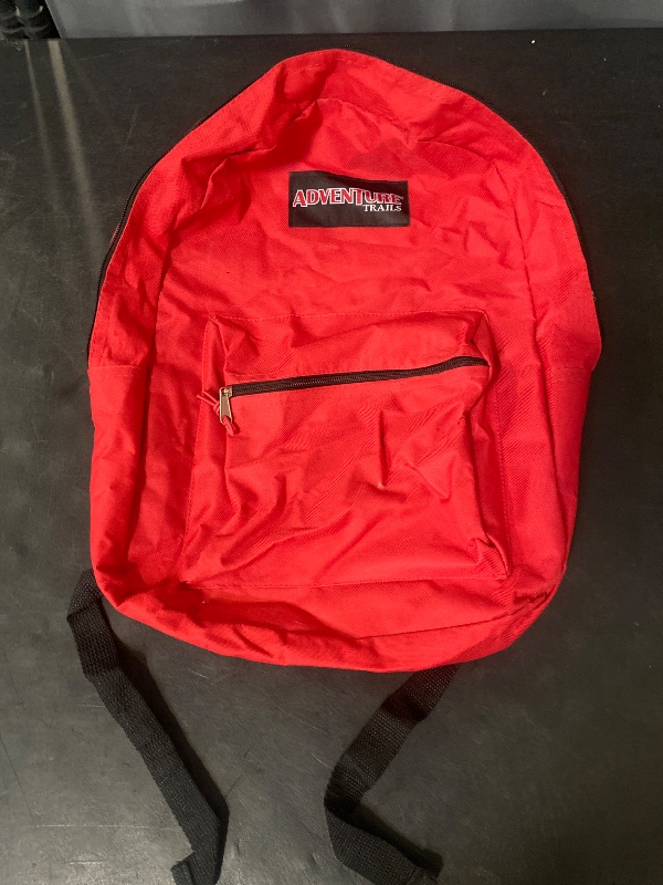 Photo 1 of 17inch red classic backpack features a front zippered pocket and an Adventure Trails brand patch on the upper body.