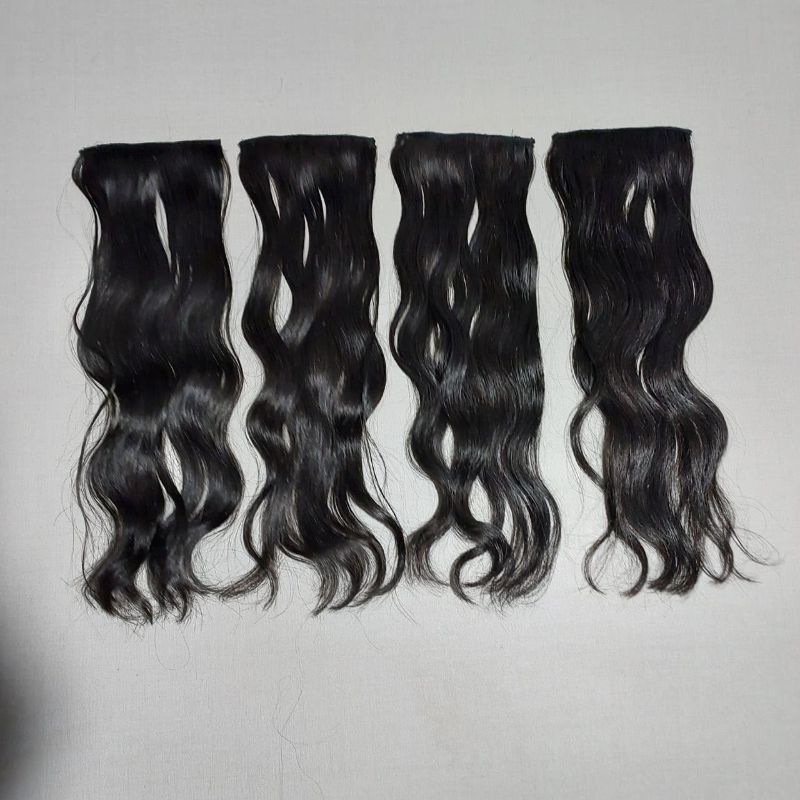 Photo 1 of 4 pc set black, wavy clip-in human hair extensions featuring attached clips at the top wefts for temporary length and volume.