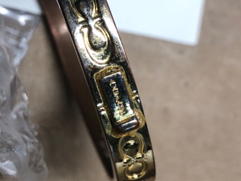 Photo 1 of ***STOCK PHOTO FOR REFERENCE ONLY, CLASP HAS BEEN GLUED*** COACH Pegged C Logo Hinged Bangle Bracelet Shiny Gold One Size