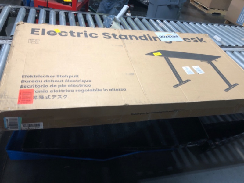 Photo 1 of *USED TOP DAMAGED*HUANUO Electric Standing Desk, Whole Piece Desktop, Adjustable Height Computer Desk, 4 Height Memory Settings, Sit Stand Up Desk for Home Office, 48" x 24", Black