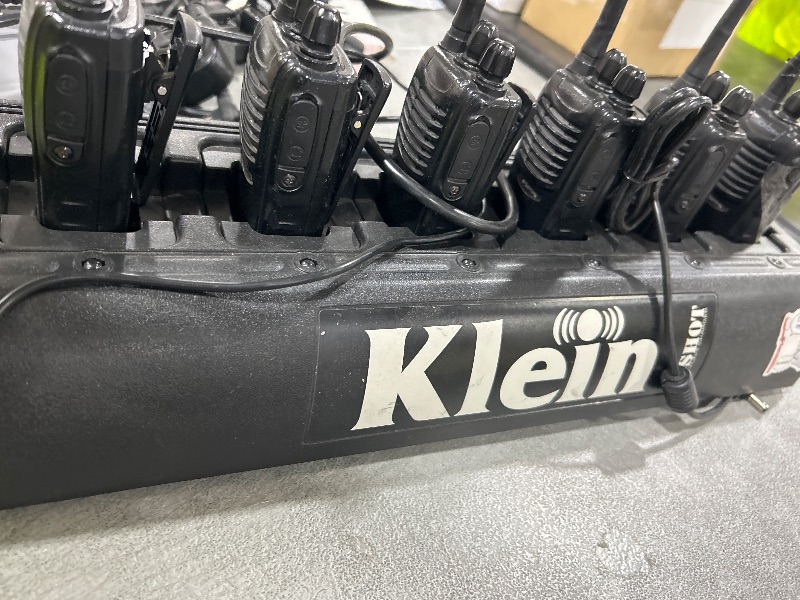 View 2 of Klein Electronics 6-Shot Slim Multi Unit Battery Charger holding six portable two-way radios/ 4PODS INCLUDED