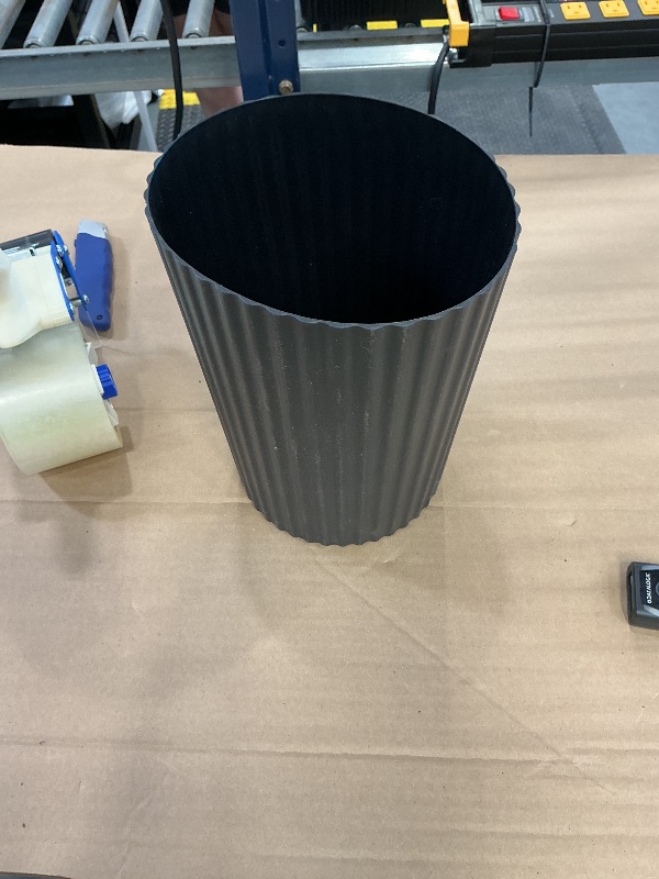 Photo 1 of black trash can