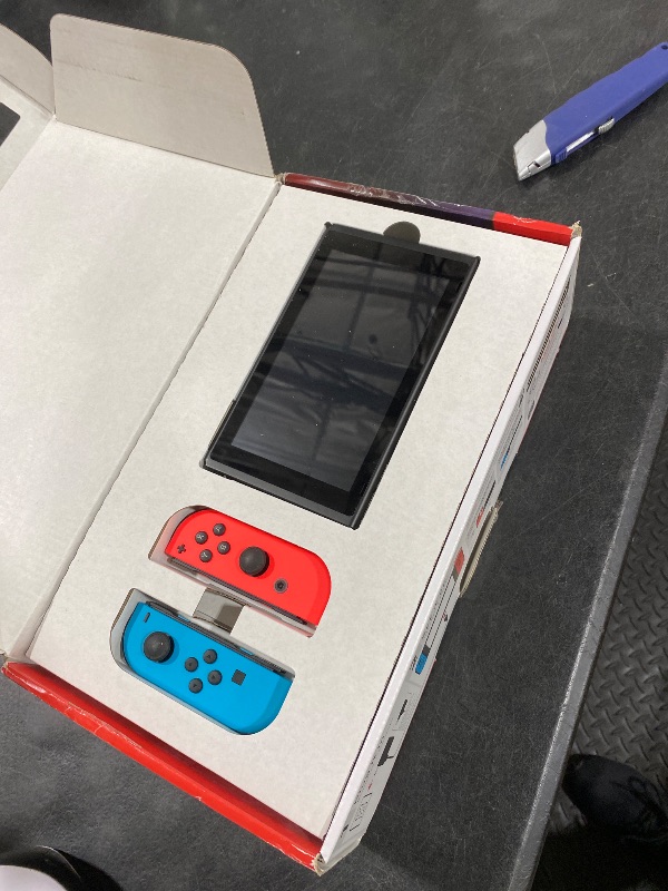 Photo 1 of Nintendo Switch Console with Neon Blue and Red Joy-Con