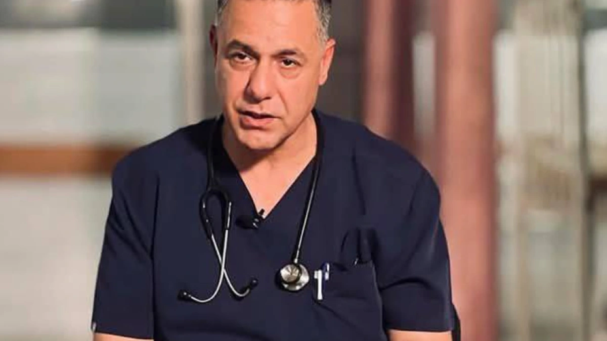 Palestinian doctor Hussam Abu Safiya speaking in medical scrubs