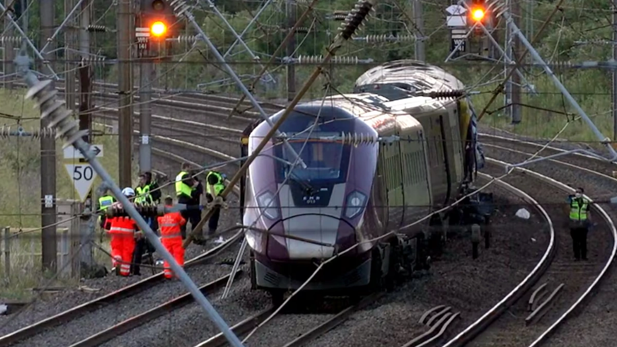 Emergency workers beside a damaged East Midlands Railway train near Bedford after a collision