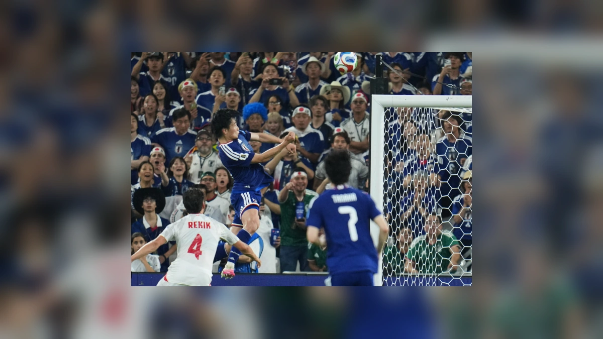 Japan player heading the ball during World Cup match against Tunisia