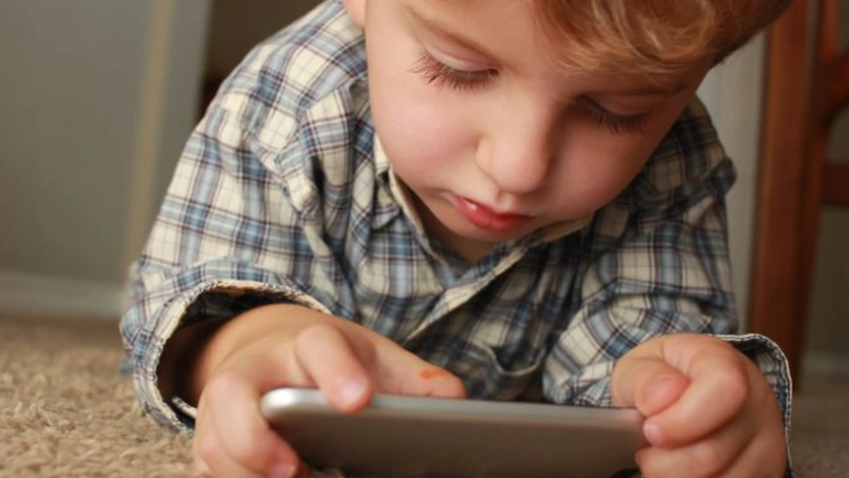 Child using a smartphone at home