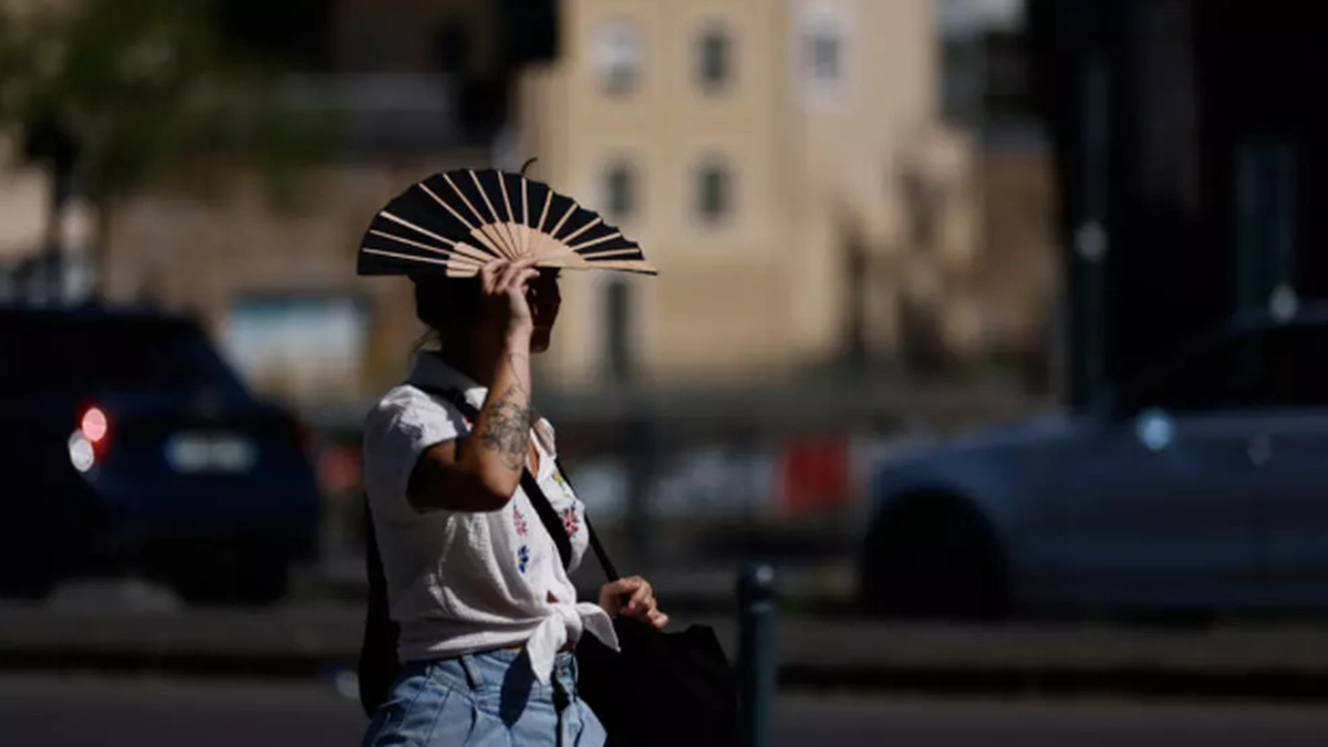 Woman shielding herself from extreme heat during European heatwave