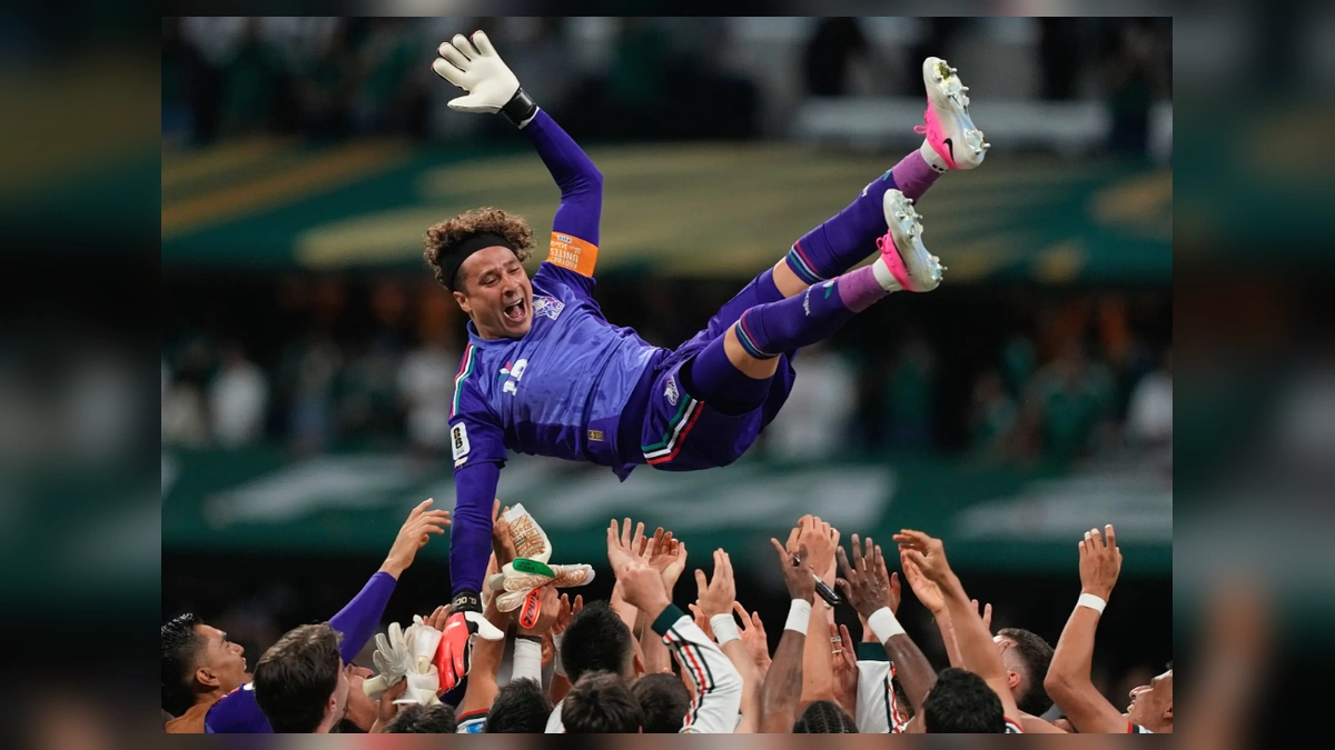 Mexico goalkeeper Guillermo Ochoa being lifted by teammates after a World Cup match