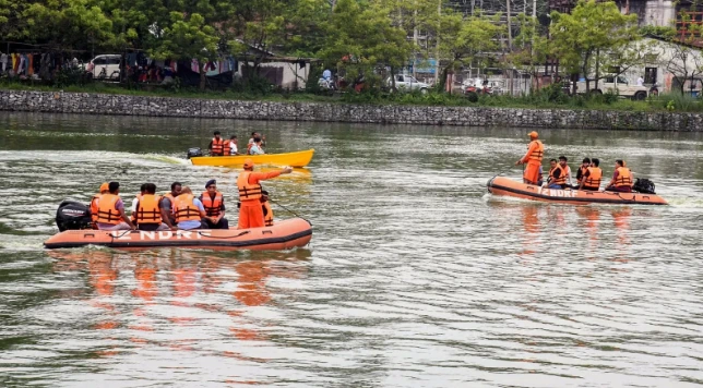 NDRF teams in boats conducting flood rescue operations in Assam
