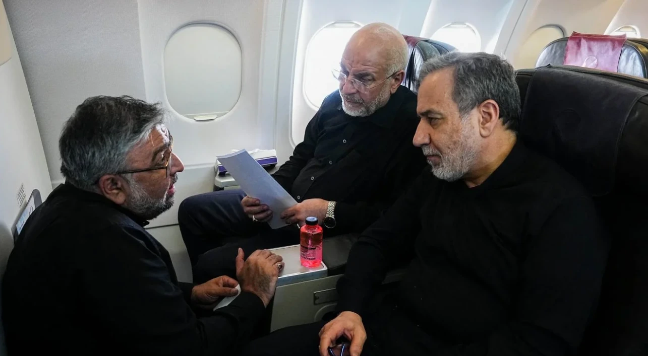 Senior Iranian officials discussing documents aboard an aircraft