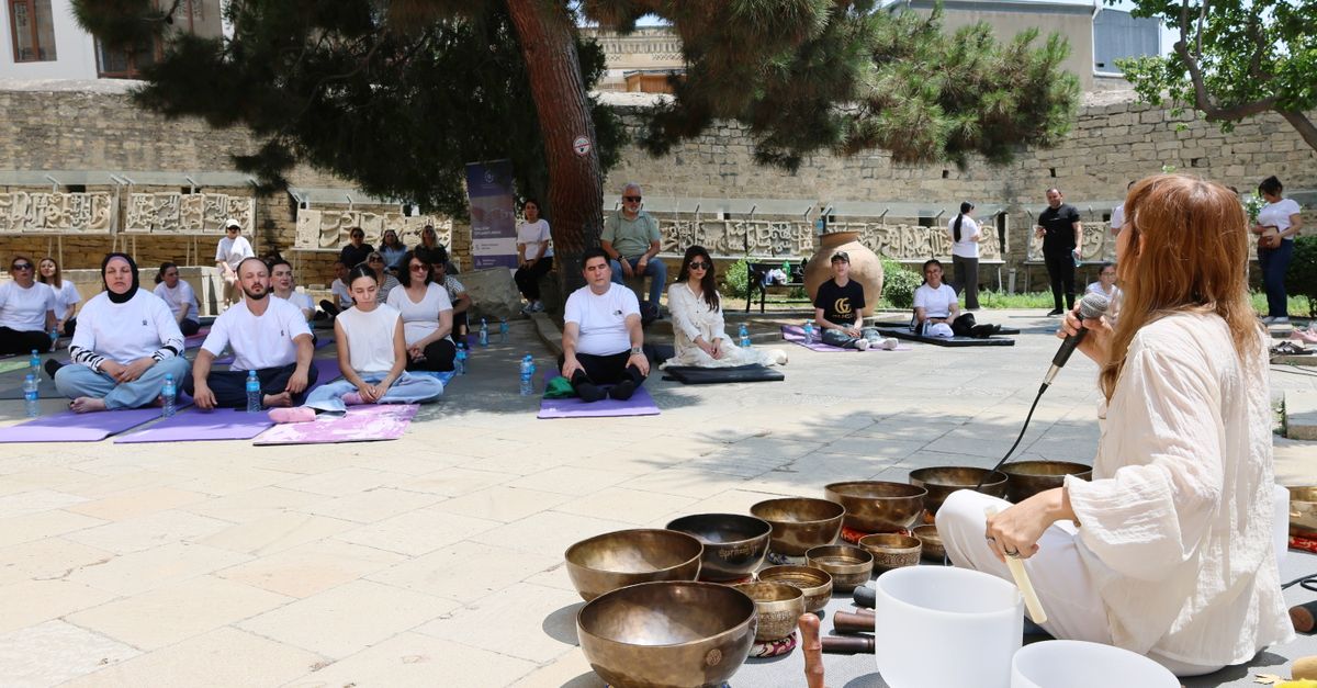 Group meditation session with singing bowls in a serene outdoor setting.