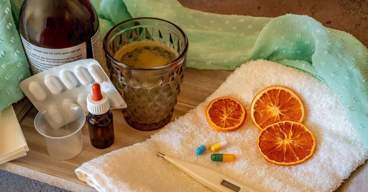 A collection of natural and medicinal cold remedies including tablets, a thermometer, and herbal drinks.